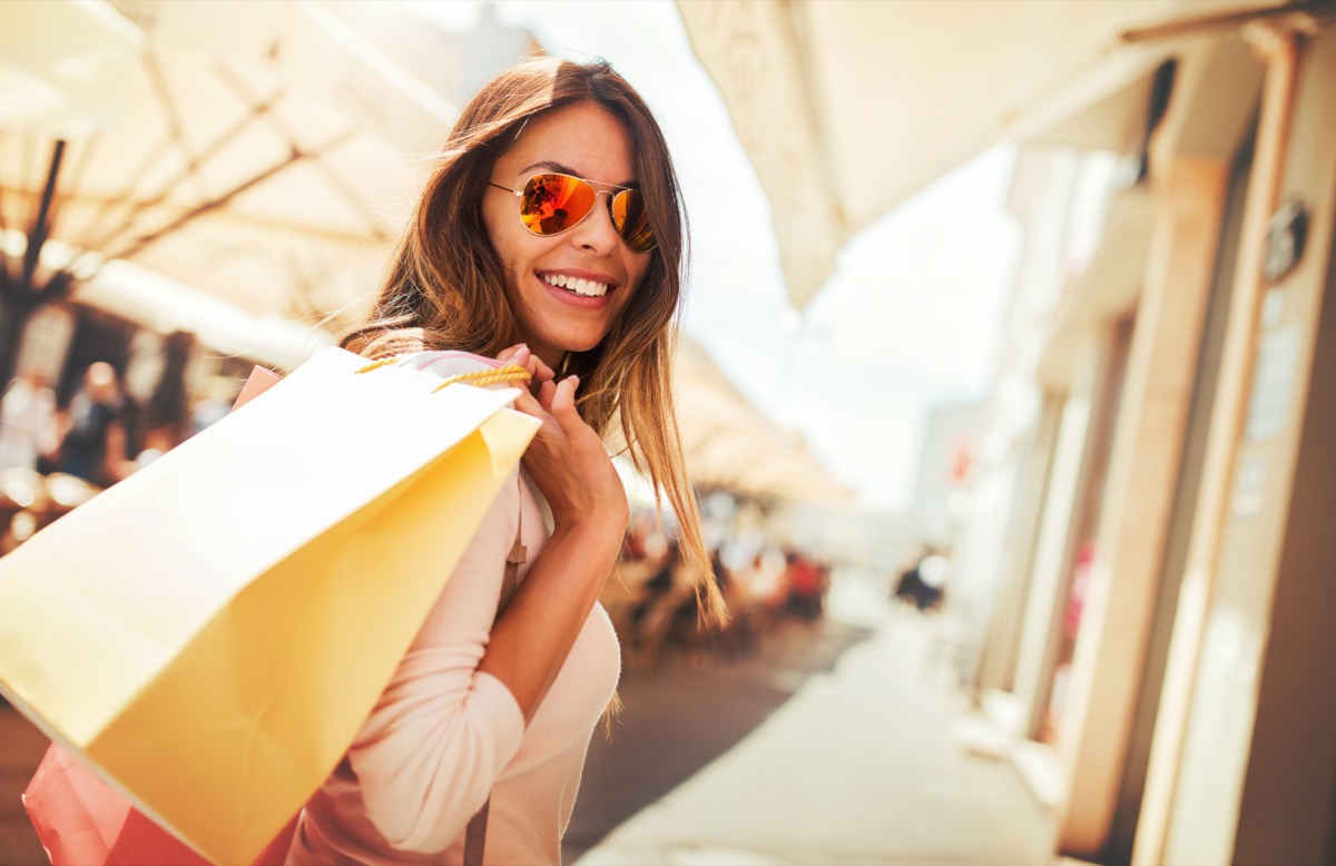 Happy woman with shopping bags enjoying in shopping.