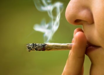 Woman smoking marijuana close up