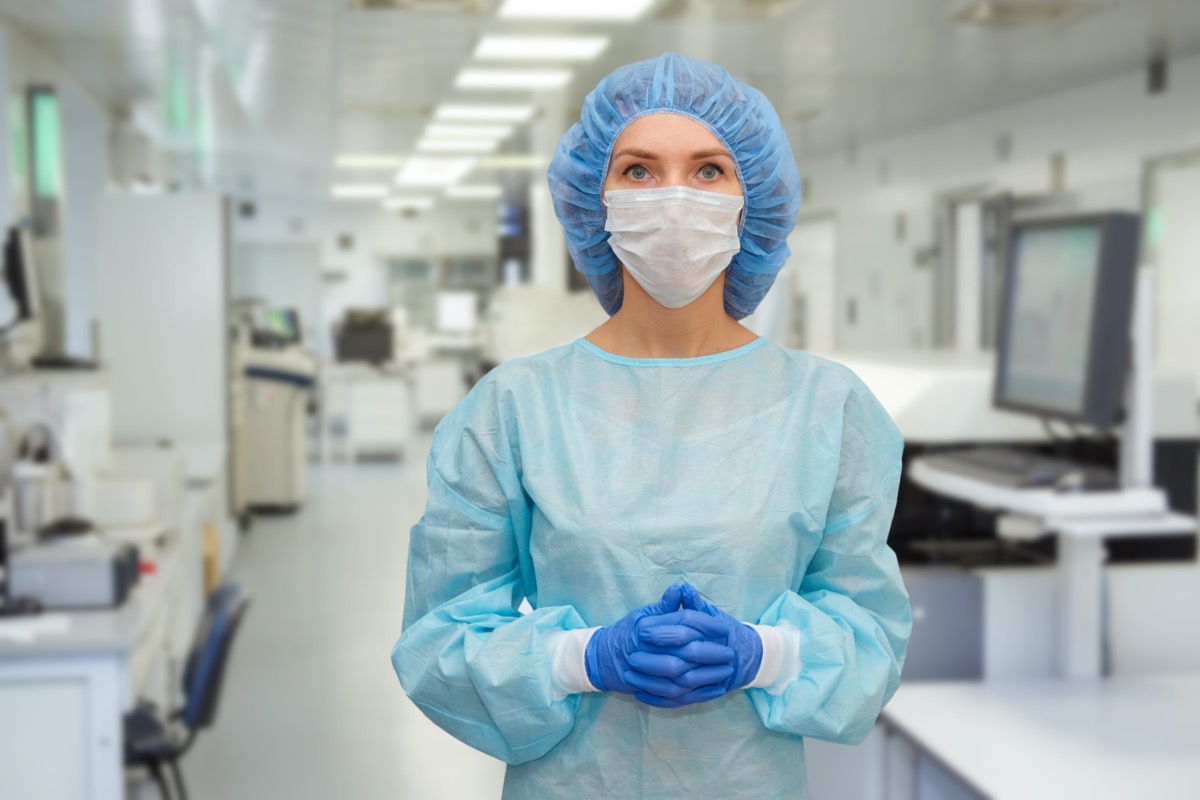 A female doctor in a protective cap and face mask in safety measures against the coronavirus.