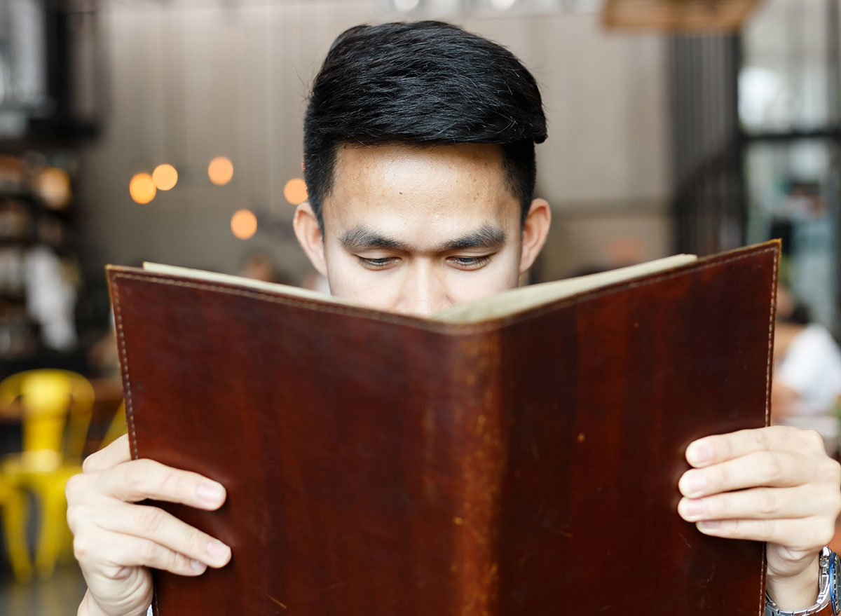 asian man reading menu