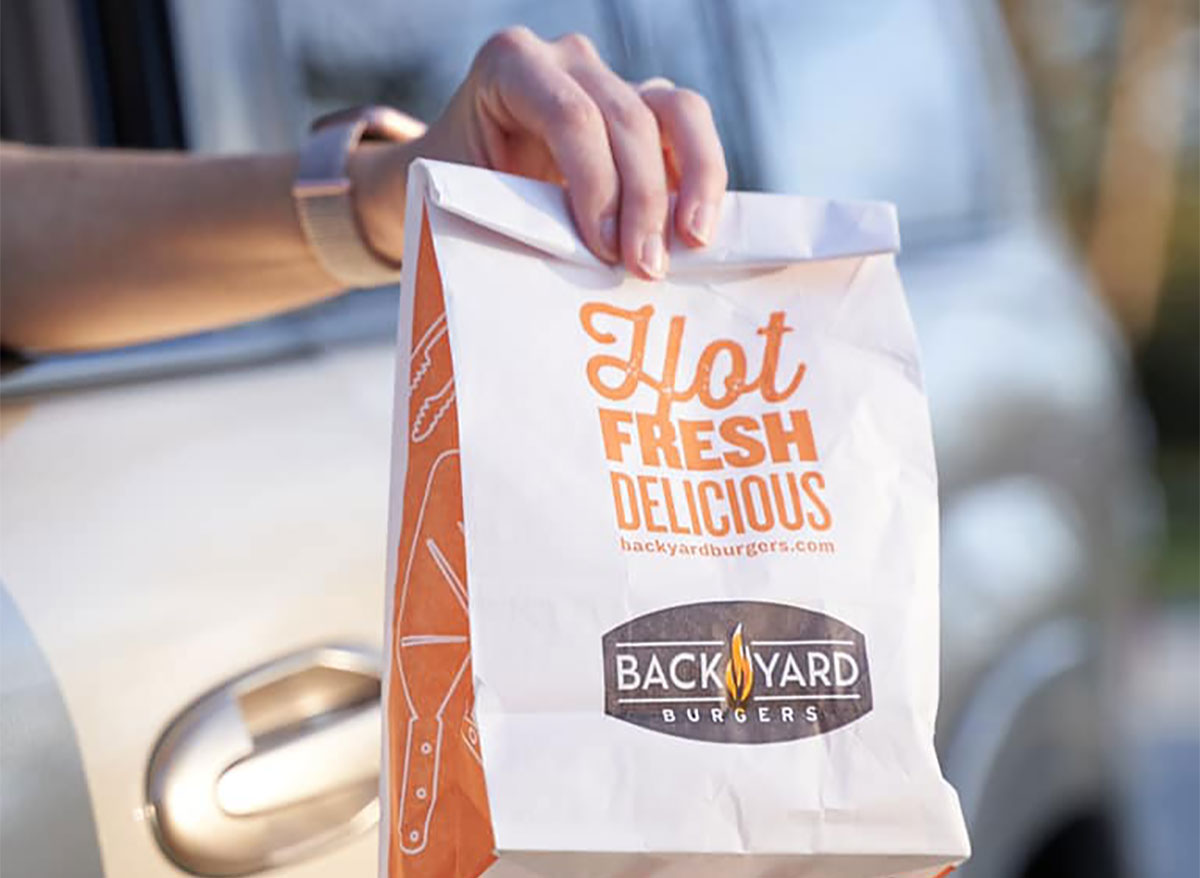 back yard burgers bag of food at drive thru