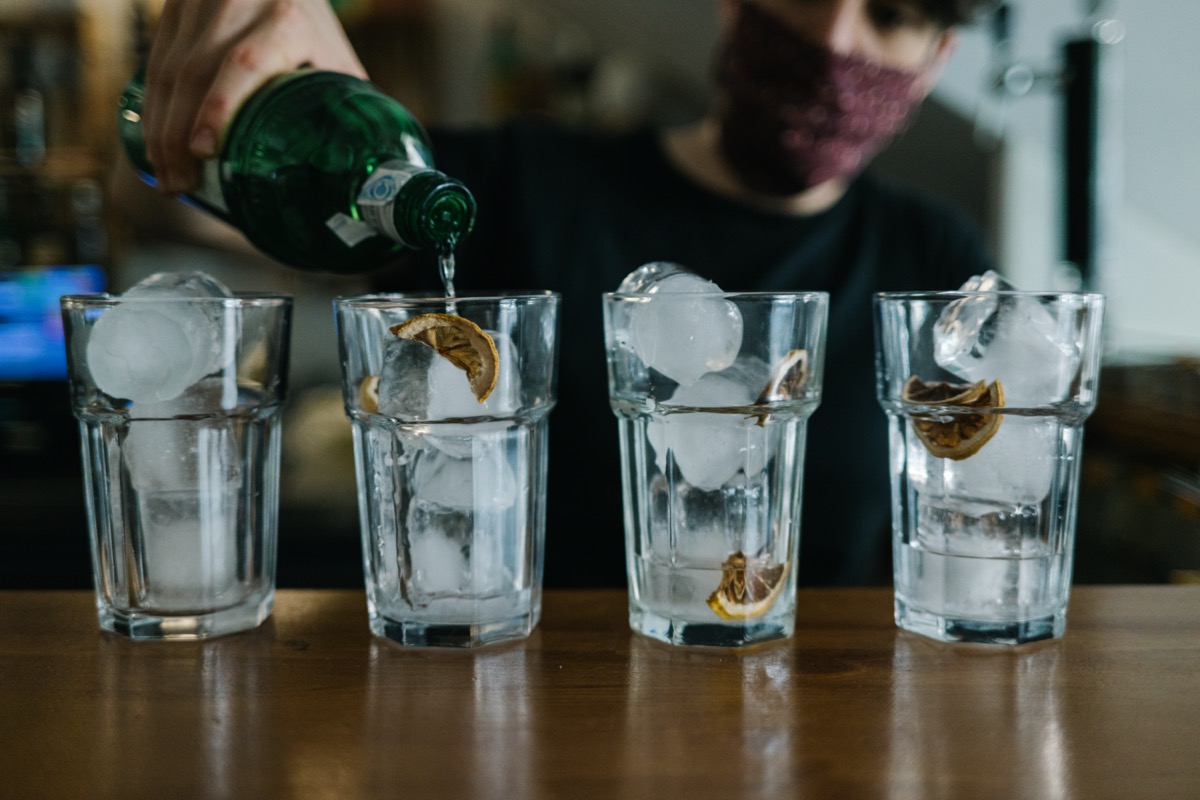 Waitress with a face mask in a bar.