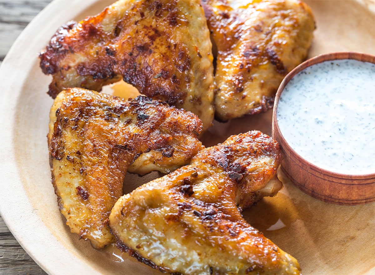 fried chicken wings on plate with white dipping sauce