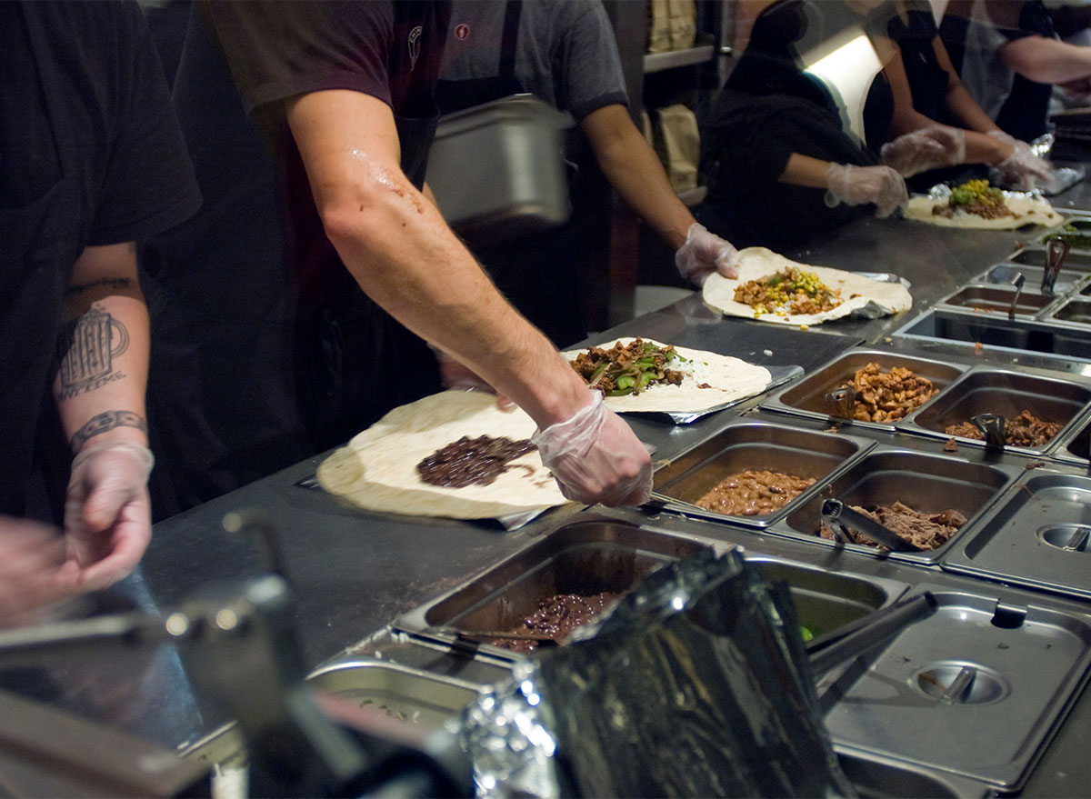 chipotle workers assembling burritos