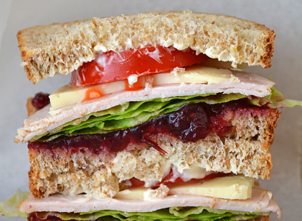 classic turkey sandwich piled high with cheese and vegetables