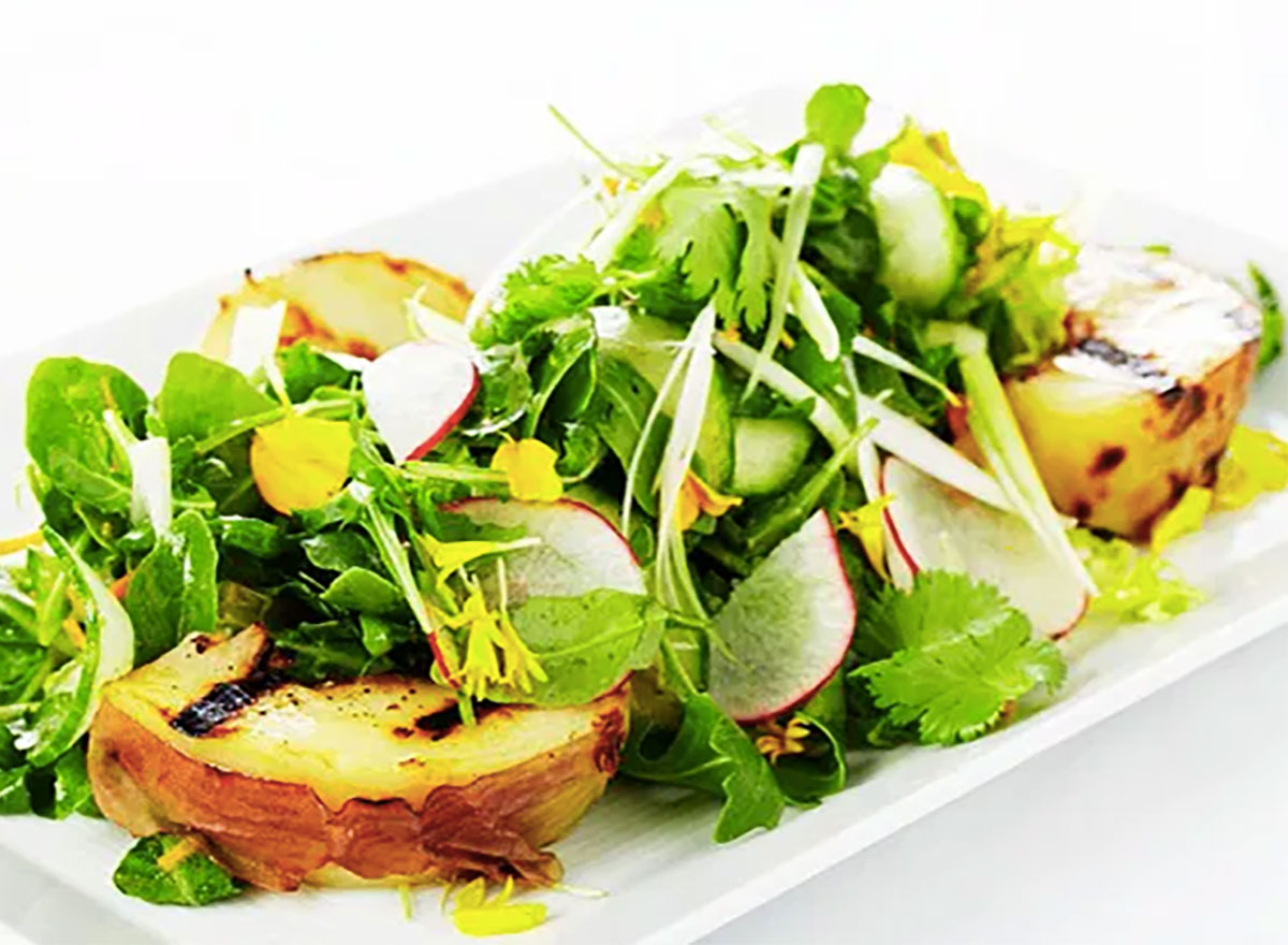 grilled pear and arugula salad on white plate