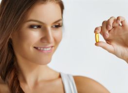 Happy Beautiful Girl With Pill With Cod Liver Oil Omega-3