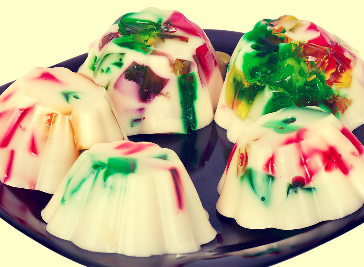 five red green and white jello molds on a serving plate