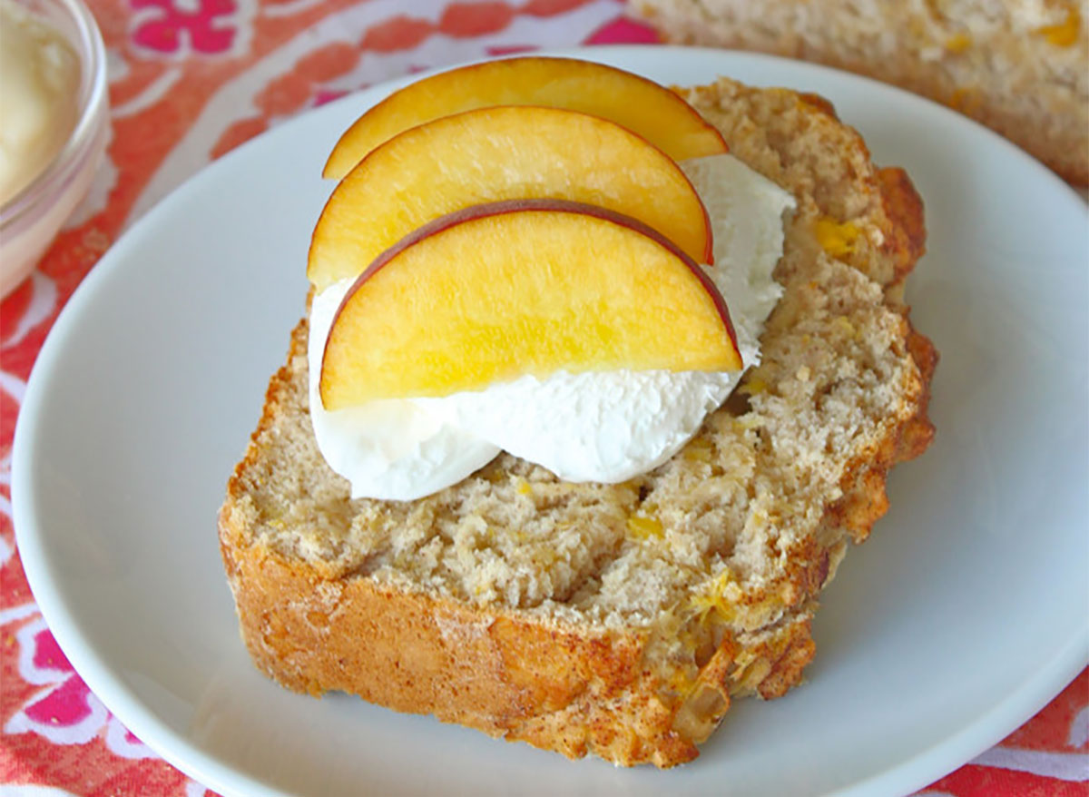 slice of peach ice cream bread topped with peach slices