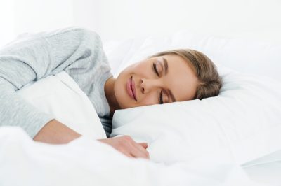 woman smiling while sleeping