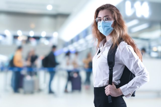 Virus mask woman travel wearing face protection in prevention for coronavirus at airport.
