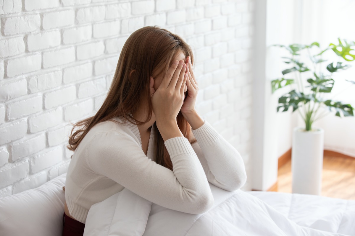 woman feeling discomfort in bed