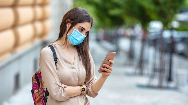 Woman phone face mask street outdoor text
