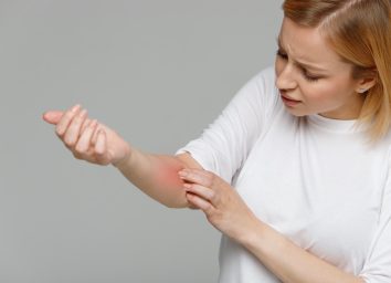 Woman removing adhesive plaster from the wound after blood test injection