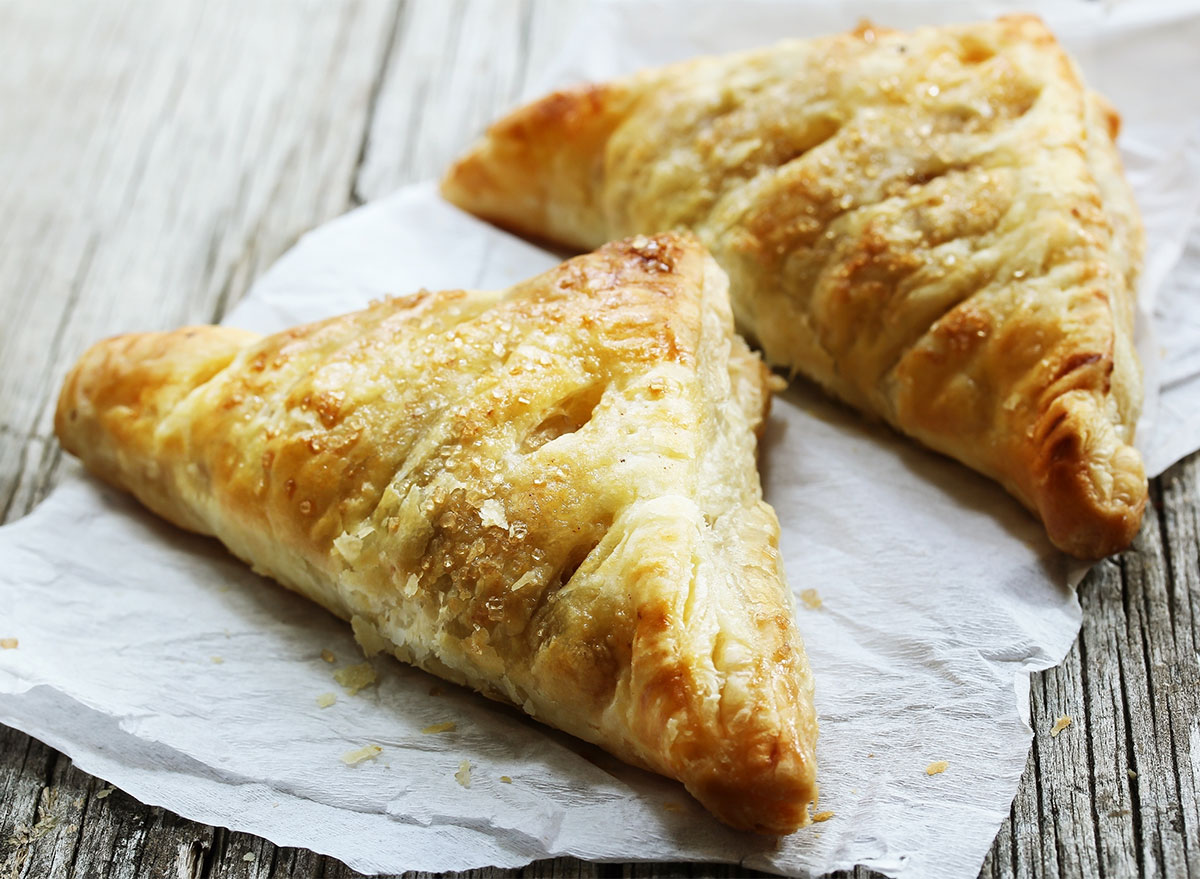 two apple turnovers on paper