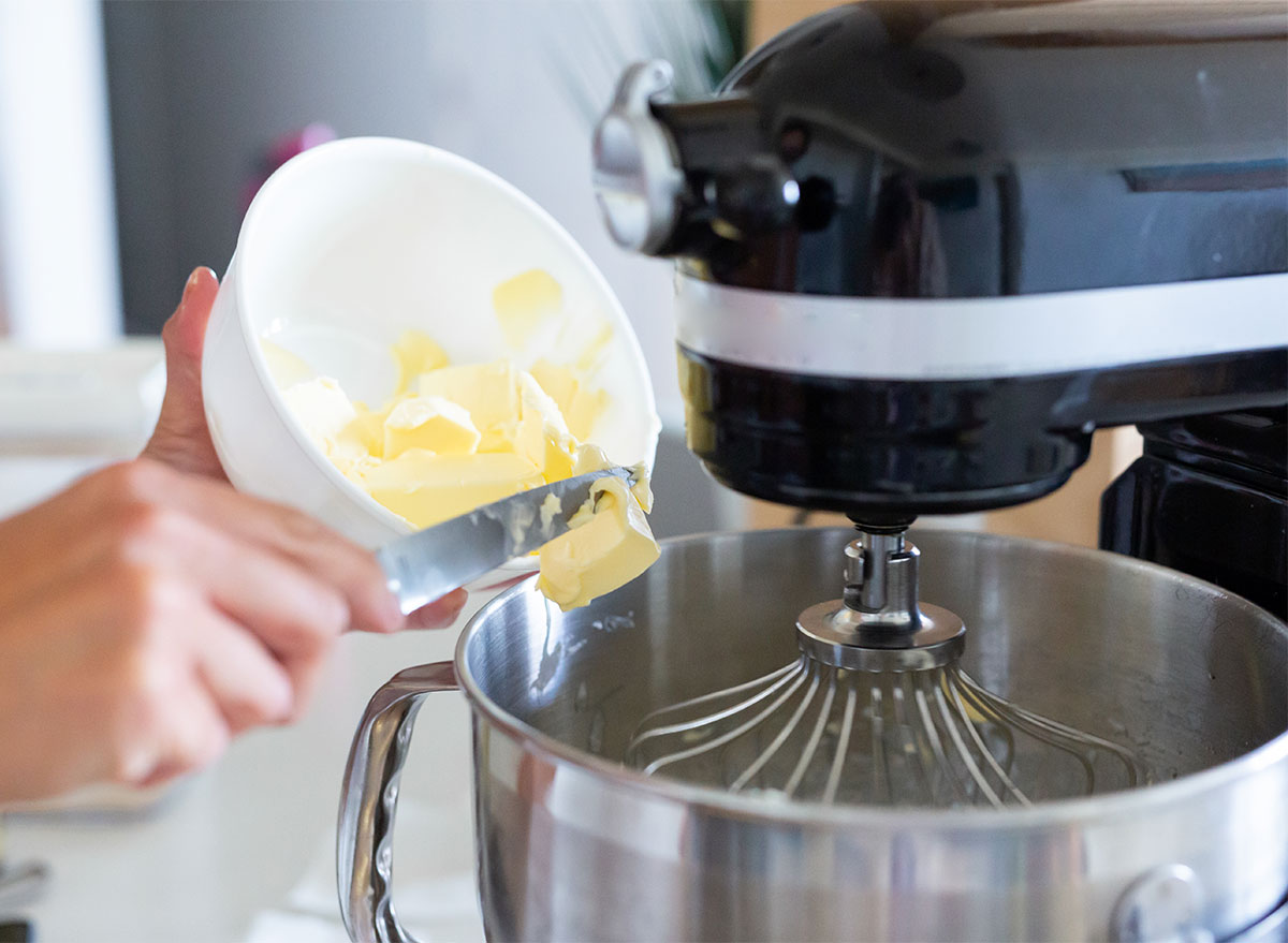 adding butter to mixing bowl