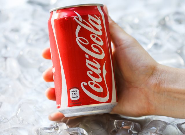 holding a can of coke