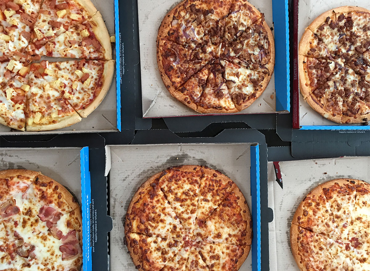 dominos pizzas in boxes on table