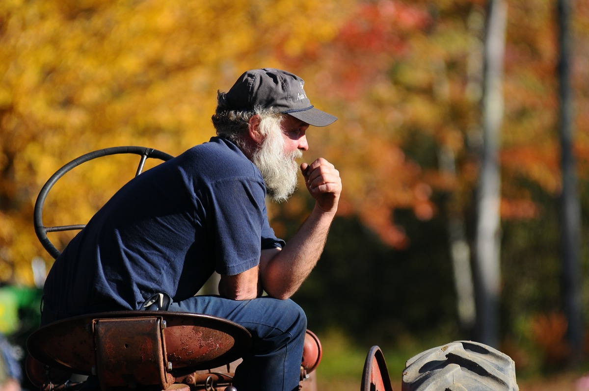 A New Hampshire farmer sits on his tractor
