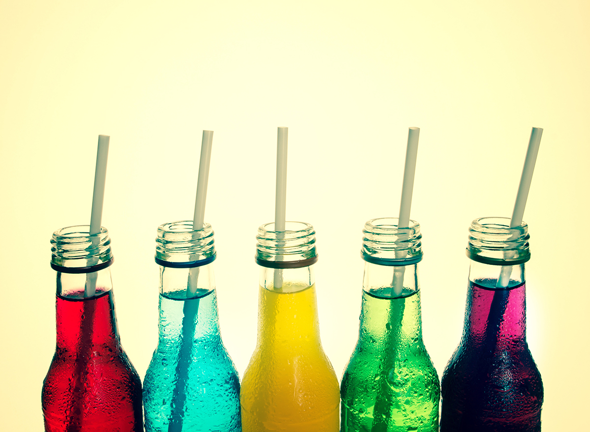 fruit flavored sodas in glass bottles with straws