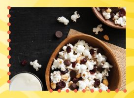 bowl of trail mix popcorn on a yellow background
