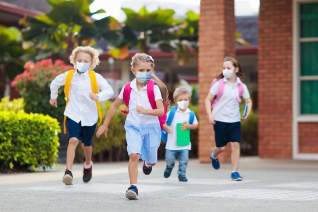 A school child wears a face mask