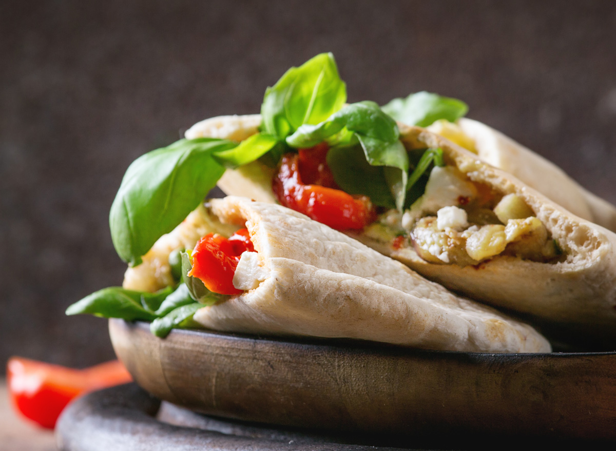 Pita pocket with hummus lettuce onion tomato