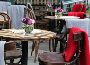 outdoor restaurant seating empty table with flowers
