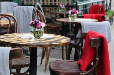 outdoor restaurant seating empty table with flowers