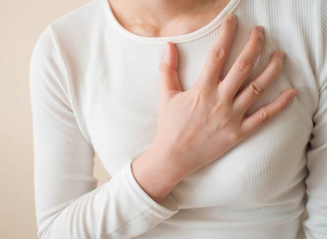 Woman experiencing heart burn and acid reflux from gastroesophageal disease