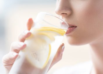 Woman drinking lemon water to be hydrated