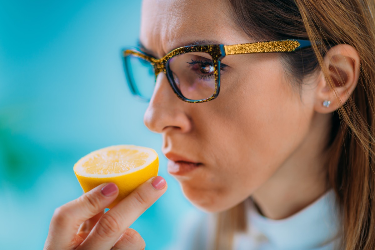 Woman smelling lemon