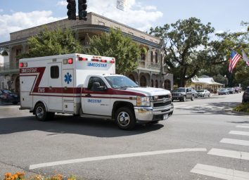An ambulance on an emergency call driving through the town center of Fairhope