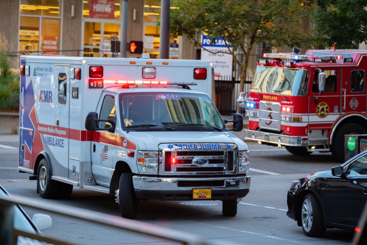 Ambulance and firefighter trucks block the street in downtown