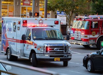 Ambulance and firefighter trucks block the street in downtown
