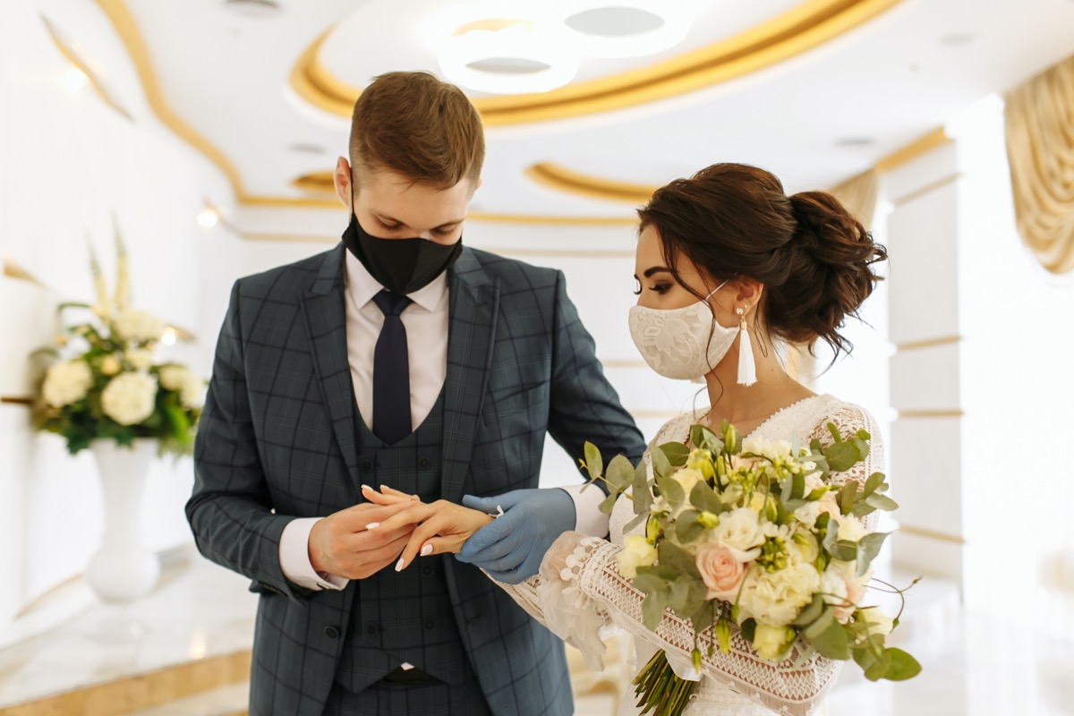 Masked bride and groom during a wedding ceremony