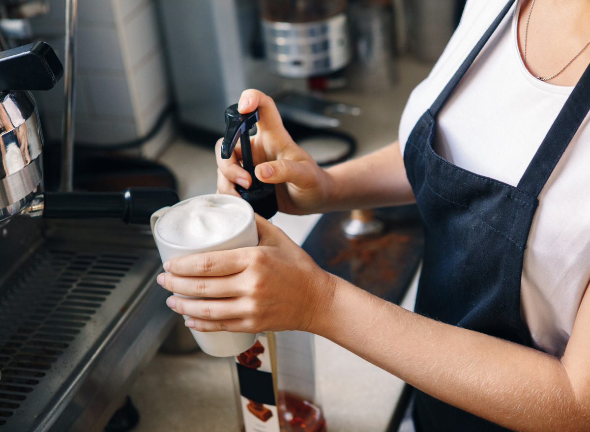 Barista adding flavored syrups for coffee