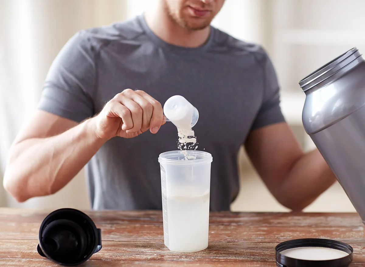 man making protein shake
