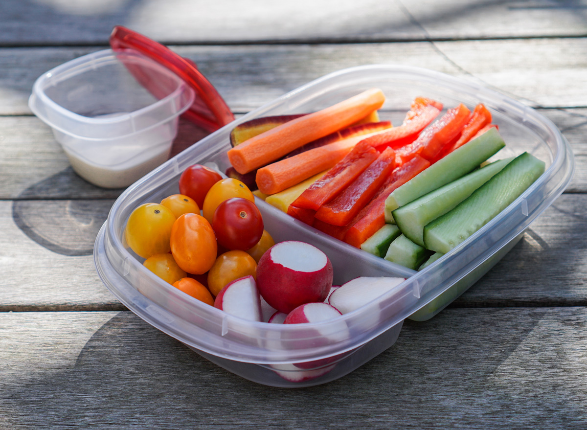 pre cut veggies carrots peppers cucumbers radishes tomatoes in meal prep container for easy snacking