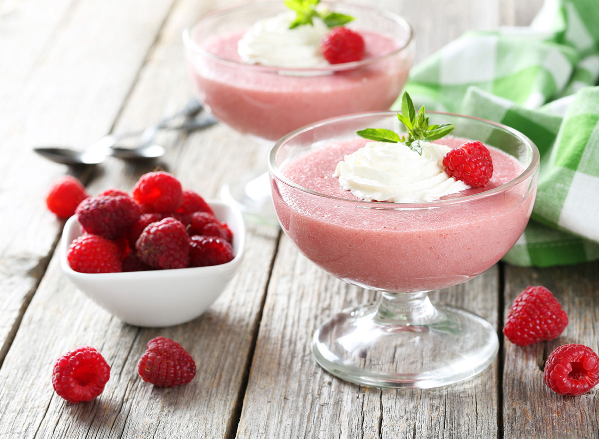 raspberry mousse in glass jars with fresh raspberries