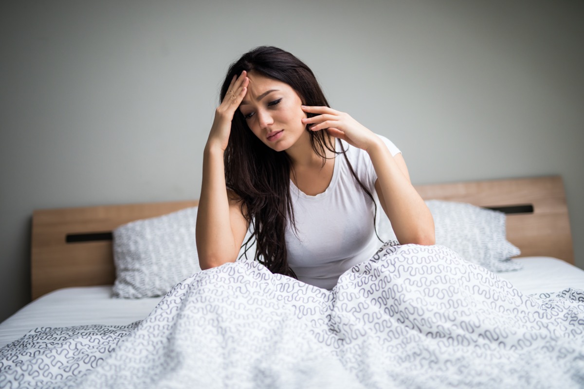 woman feel sick and unwell on bed