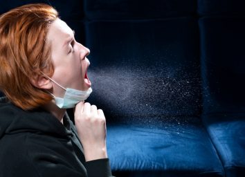 Woman sneezing.