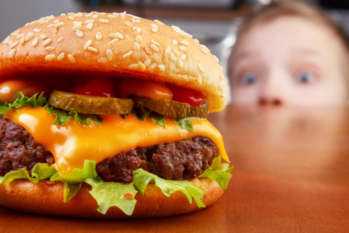boy staring at a burger