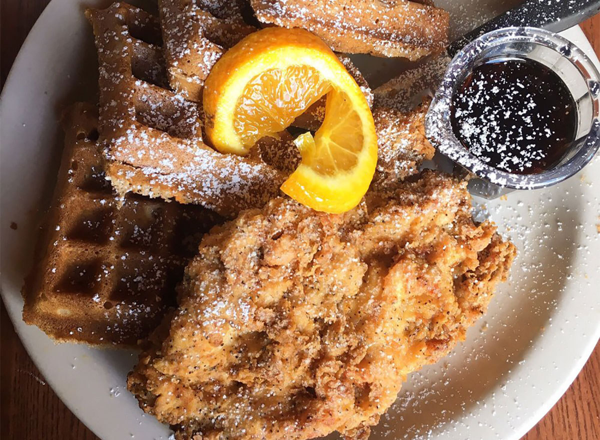 plate of chicken and waffles with syrup