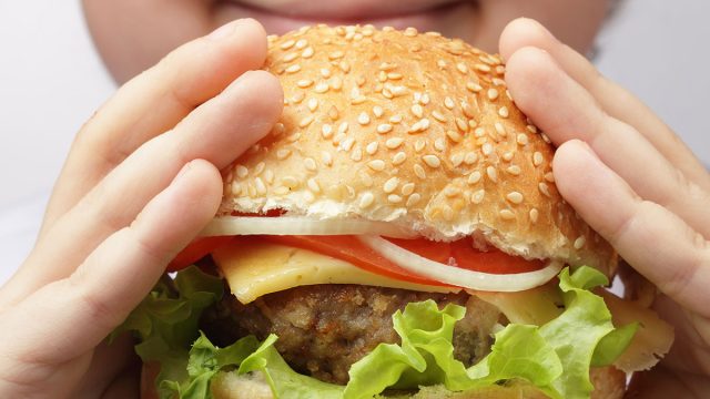 child eating burger