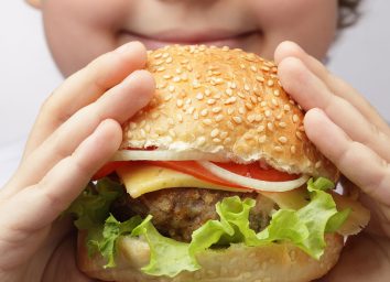 child eating burger