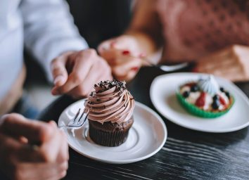 man and woman eating dessert