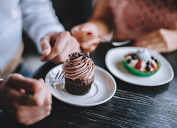 man and woman eating dessert