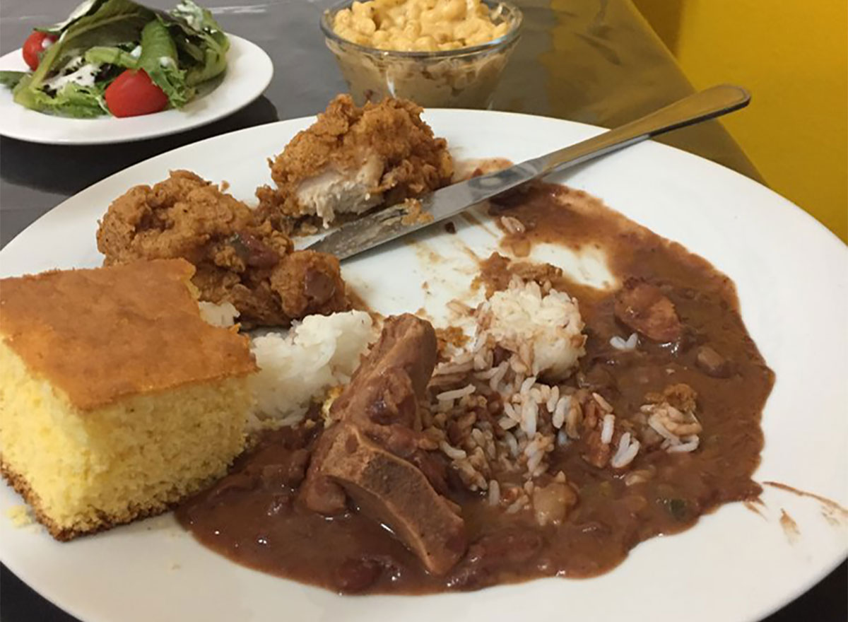 plate of fried chicken with rice and beans and cornbread