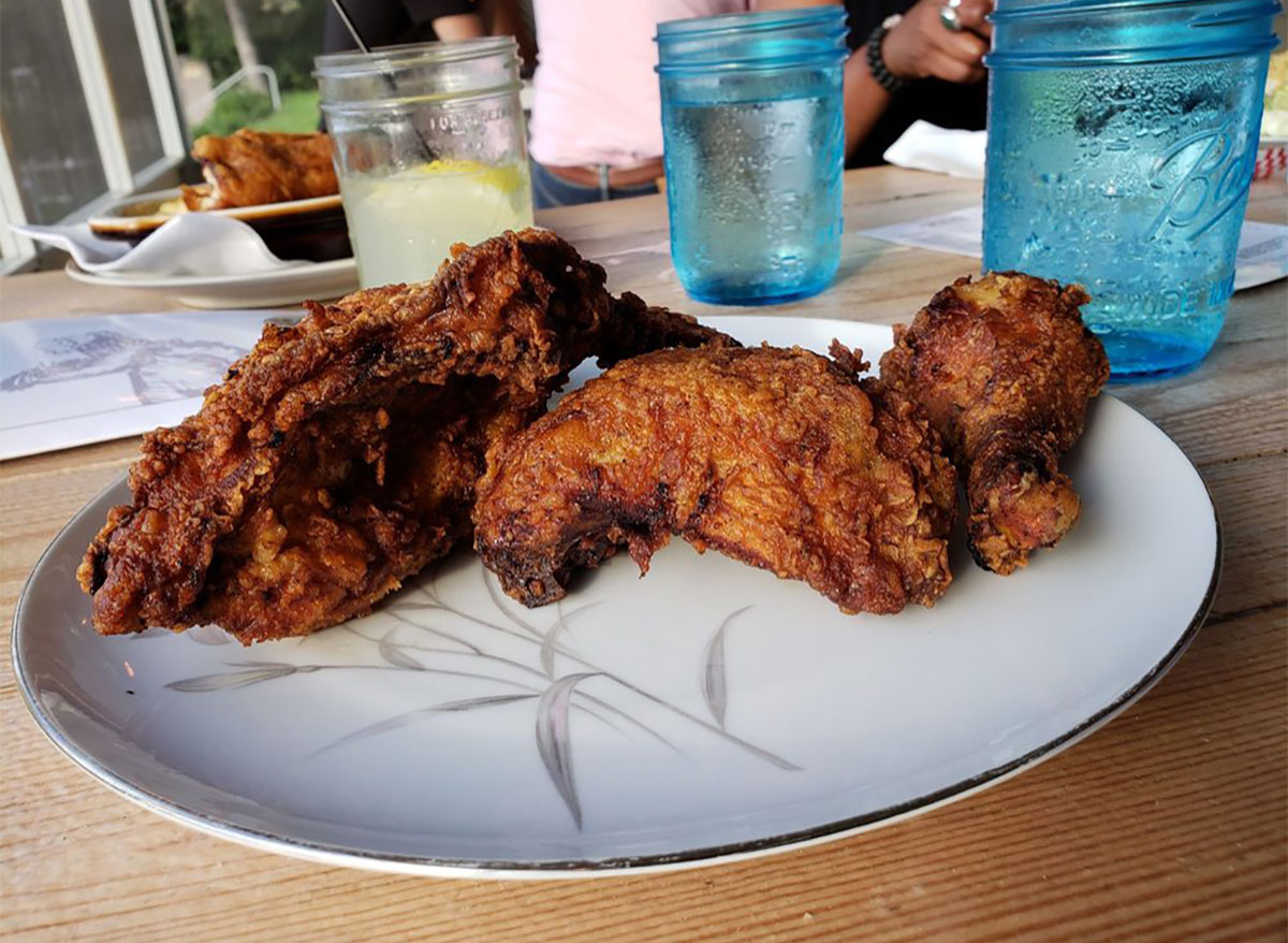 plate of fried chicken with mason jars of water